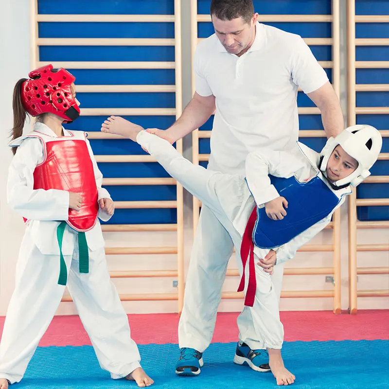 Happy kids in San Dimas learning martial arts, improving balance, coordination, and having fun while building life skills.